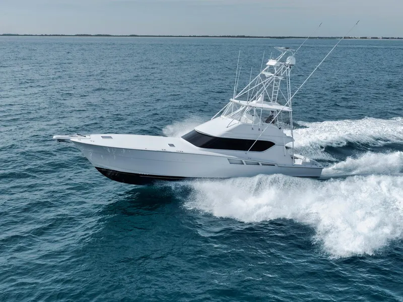 Slide: The Image of 1999 Hatteras 60 Convertible yacht cruising on open water. - 5