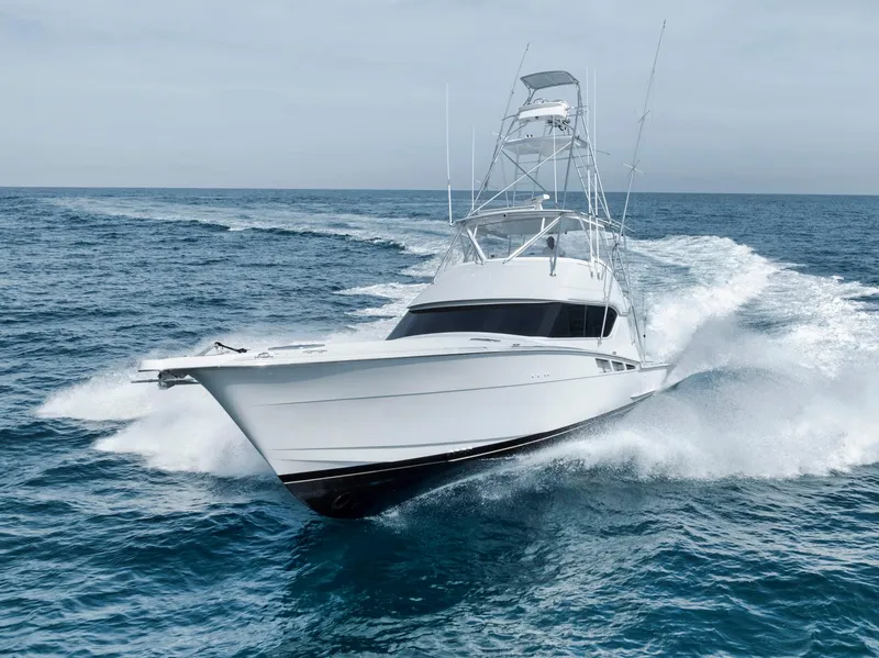 Slide: The Image of 1999 Hatteras 60 Convertible yacht cruising on open sea. - 6