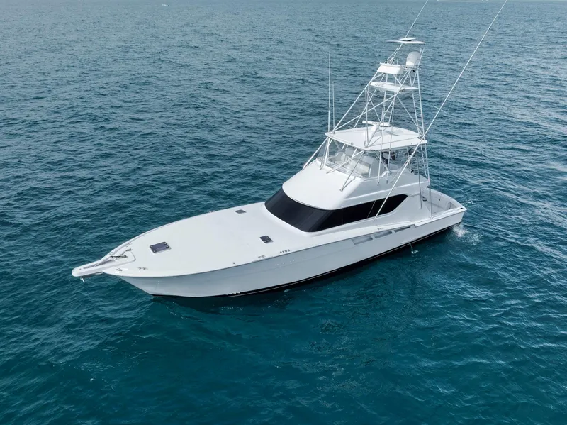 Slide: The Image of 1999 Hatteras 60 Convertible yacht cruising on open water. - 9