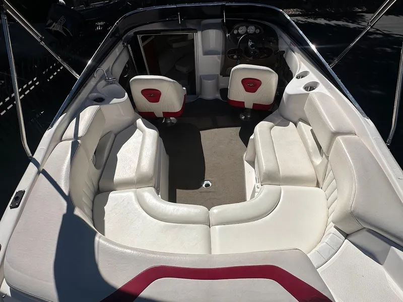 Slide: The Image of 2006 Regal 2450 Cuddy boat interior with white seating and red accents. - 15