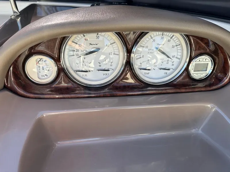 Slide: The Image of Dashboard gauges of a 2006 Regal 2450 Cuddy boat, featuring speedometer and fuel indicators. - 23