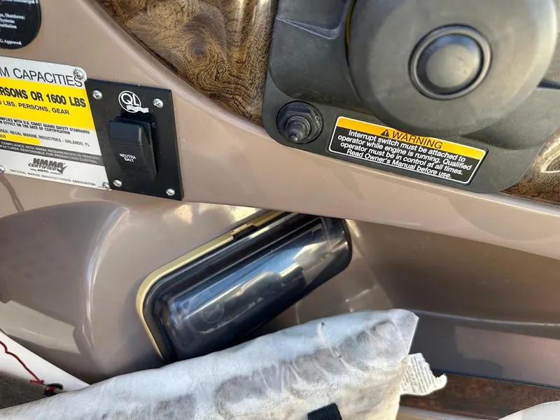 Slide: The Image of Control panel of a 2006 Regal 2450 Cuddy boat with warning labels. - 24