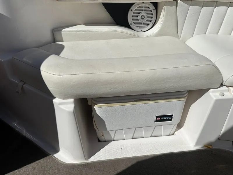 Slide: The Image of 2006 Regal 2450 Cuddy boat interior with cushioned seating and built-in speaker. - 26
