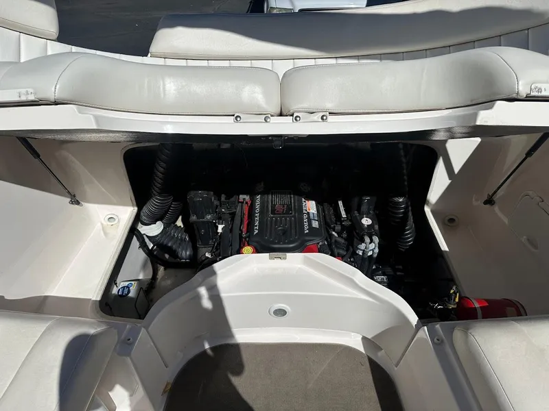 Slide: The Image of Engine compartment of a 2006 Regal 2450 Cuddy boat, showcasing interior details. - 30