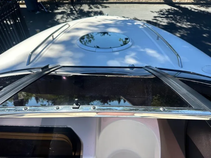 Slide: The Image of 2006 Regal 2450 Cuddy boat deck with hatch and windshield, viewed from above. - 32