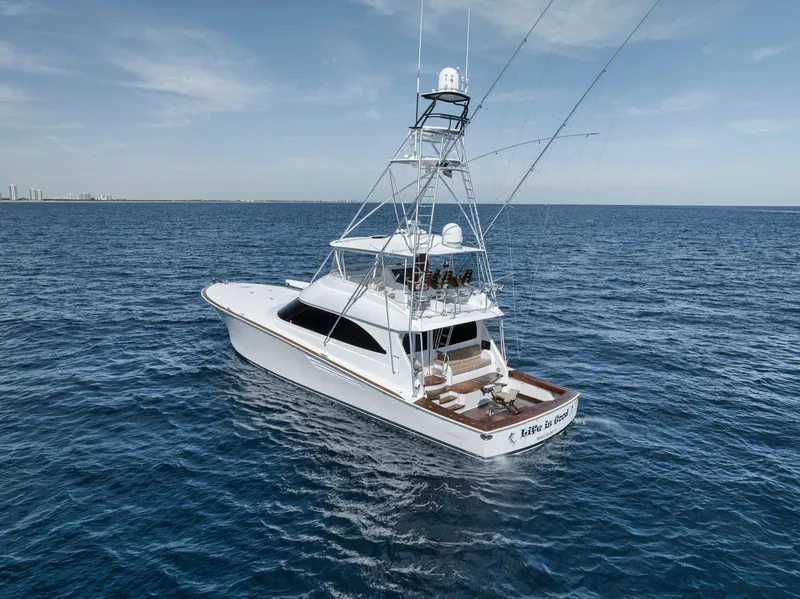 Slide: The Image of 2015 Viking 70 Convertible yacht cruising on open sea under clear skies. - 11