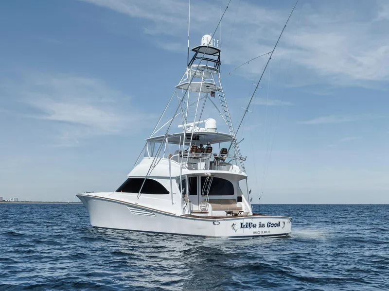 Slide: The Image of 2015 Viking 70 Convertible yacht on open sea under clear sky. - 12