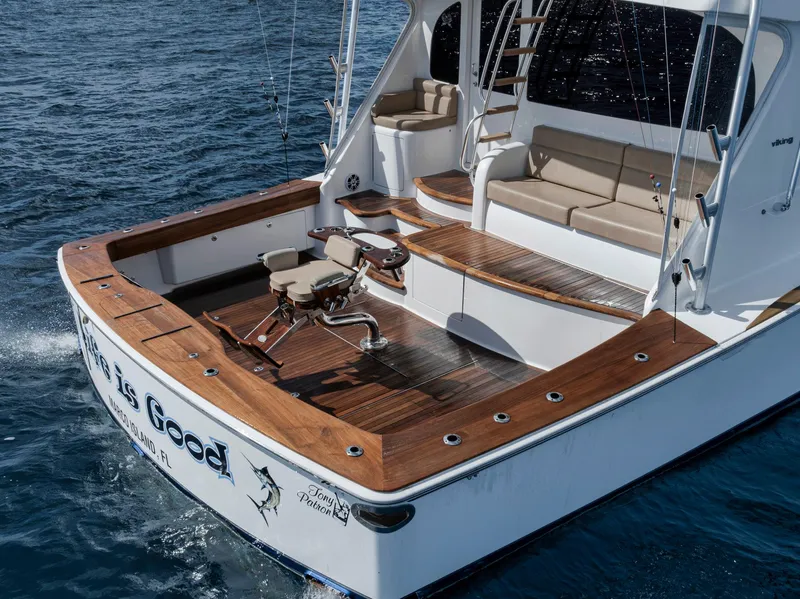 Slide: The Image of 2015 Viking 70 Convertible yacht with spacious deck and fishing chair on open water. - 19