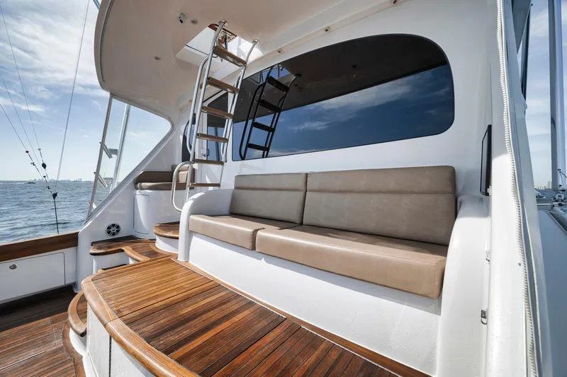 Slide: The Image of 2015 Viking 70 Convertible yacht with elegant seating and wooden deck. - 23
