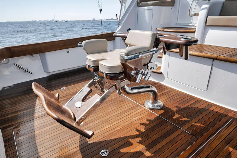 Slide: The Image of Viking 70 Convertible 2015 yacht deck with fishing chair, wooden flooring, and ocean view. - 24