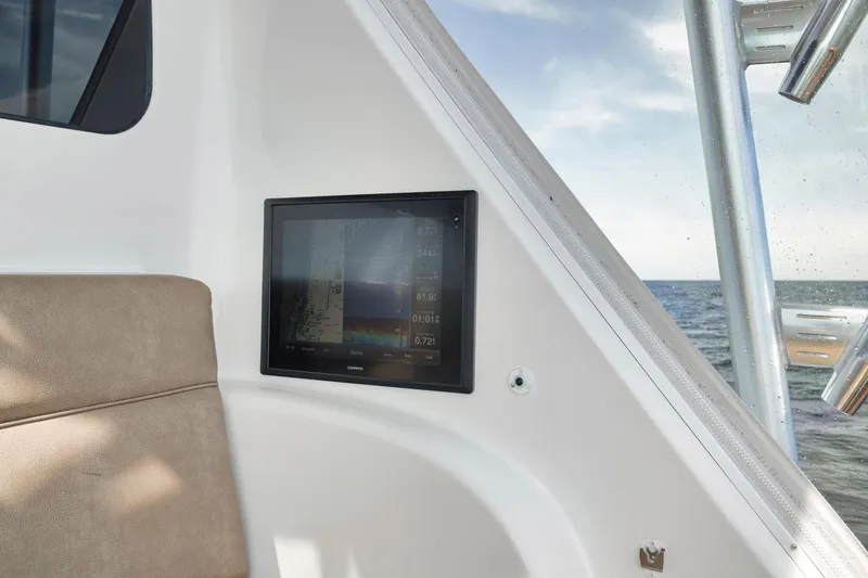 Slide: The Image of Viking 70 Convertible 2015 boat interior with navigation screen and ocean view. - 25