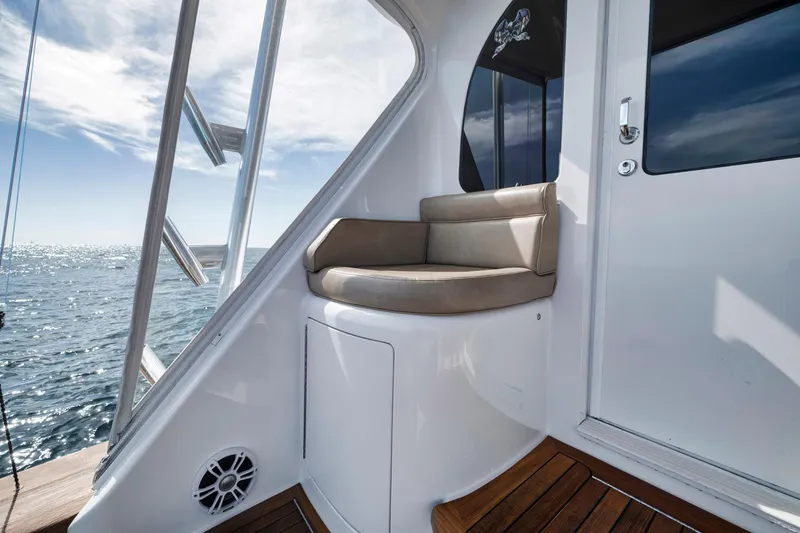 Slide: The Image of 2015 Viking 70 Convertible yacht with cushioned seating and ocean view. - 26