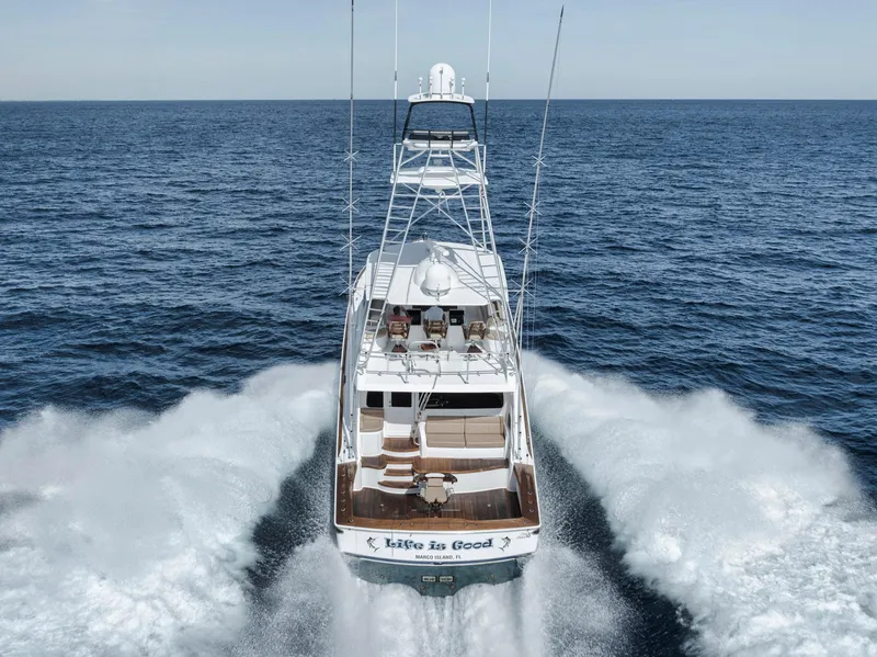 Slide: The Image of 2015 Viking 70 Convertible yacht cruising on open sea, rear view. - 3