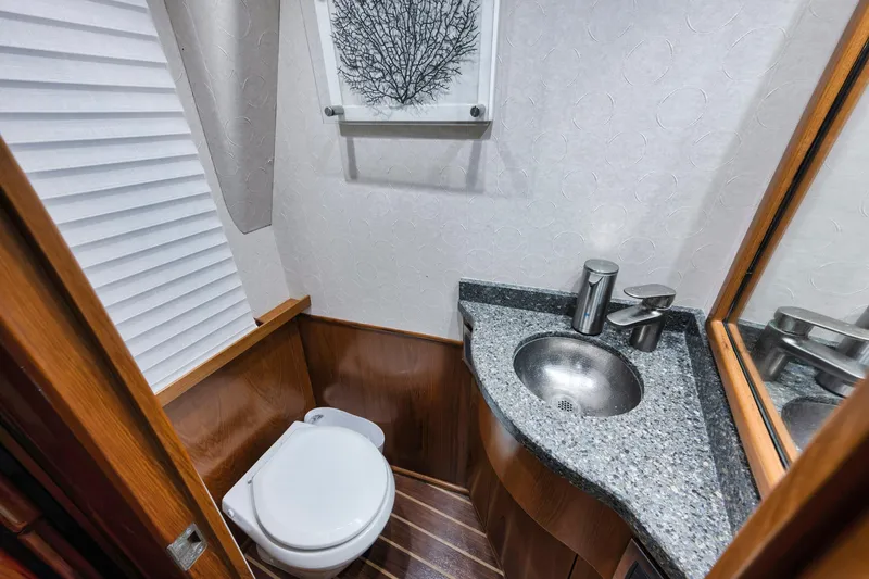Slide: The Image of Luxurious bathroom in 2015 Viking 70 Convertible yacht with modern fixtures and elegant design. - 31
