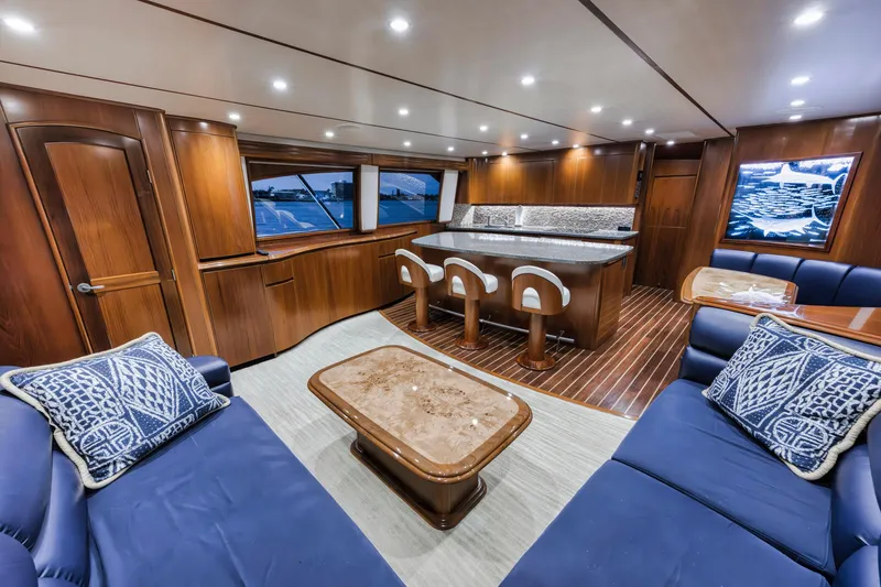 Slide: The Image of Luxurious interior of 2015 Viking 70 Convertible yacht with elegant wood finishes and plush seating. - 34