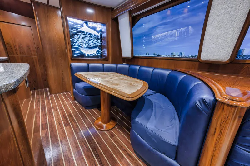 Slide: The Image of Luxurious interior of 2015 Viking 70 Convertible yacht with blue seating and wooden accents. - 36