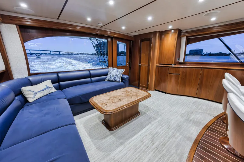 Slide: The Image of Luxurious interior of 2015 Viking 70 Convertible yacht with blue seating and wooden accents. - 38