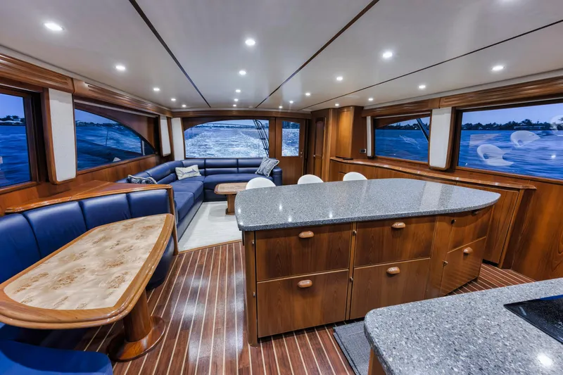 Slide: The Image of Luxurious interior of 2015 Viking 70 Convertible yacht with elegant wood finishes and spacious seating. - 42
