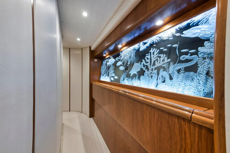 Slide: The Image of Luxurious hallway in 2015 Viking 70 Convertible yacht with illuminated marine-themed wall art. - 43