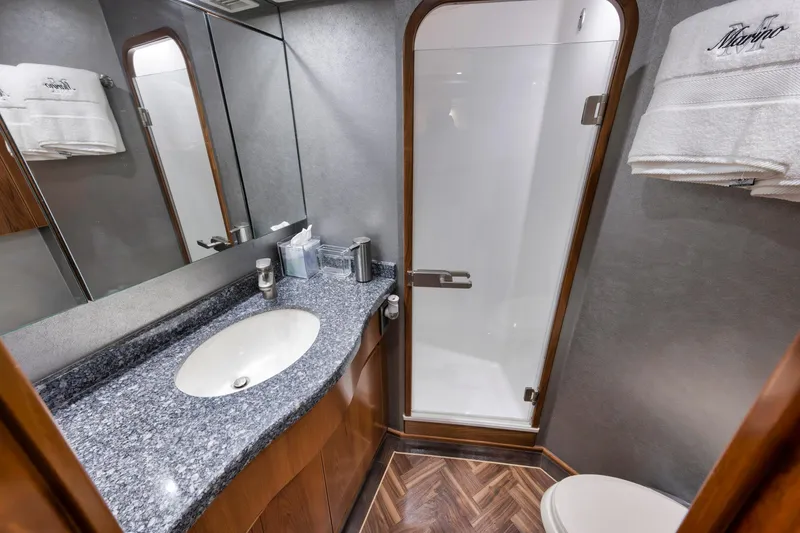 Slide: The Image of Luxurious bathroom in 2015 Viking 70 Convertible yacht with modern fixtures and elegant design. - 47