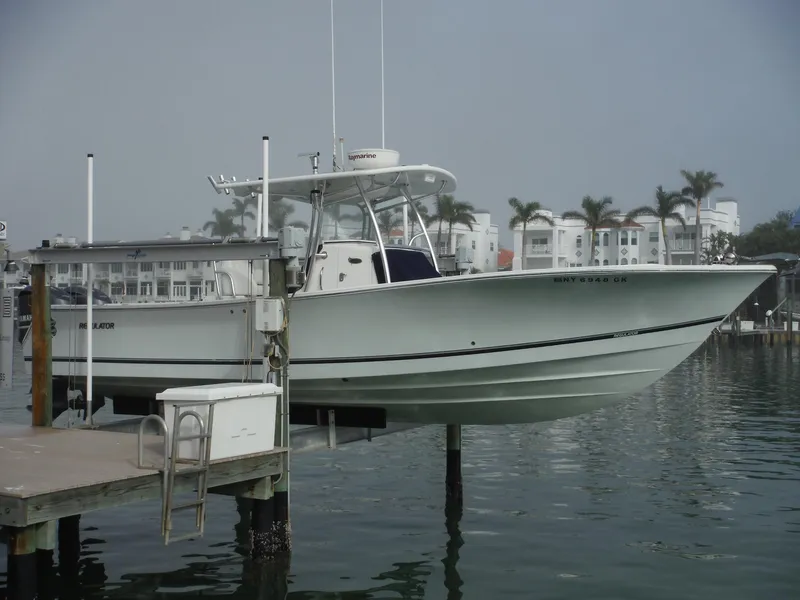 Slide: The Image of 2012 Regulator 32 Forward Seating boat docked near waterfront buildings. - 0