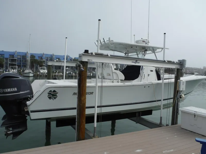 Slide: The Image of 2012 Regulator 32 Forward Seating boat docked with Yamaha outboard motor. - 1