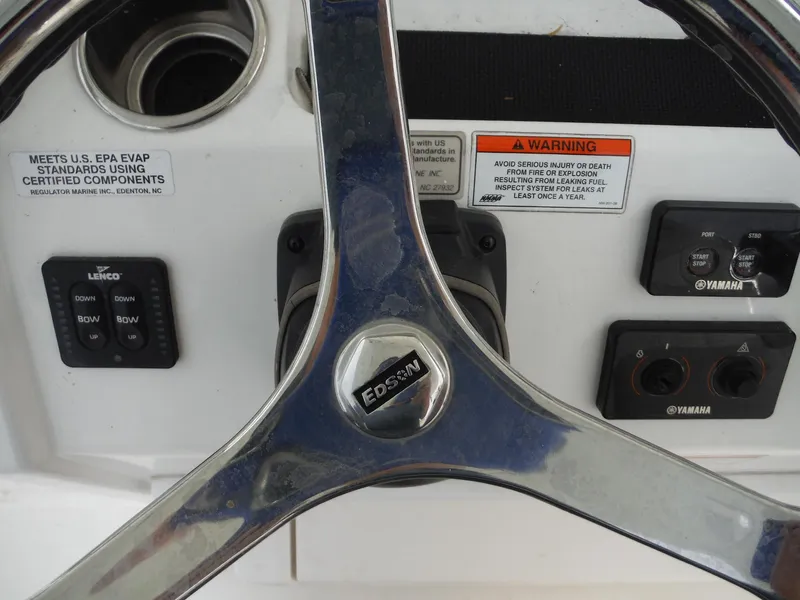 Slide: The Image of Steering wheel of 2012 Regulator 32 Forward Seating boat with control panel. - 22