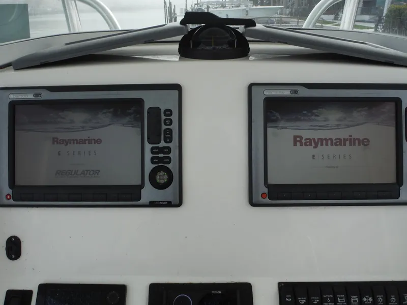 Slide: The Image of 2012 Regulator 32 Forward Seating boat dashboard with dual Raymarine E-Series displays. - 32
