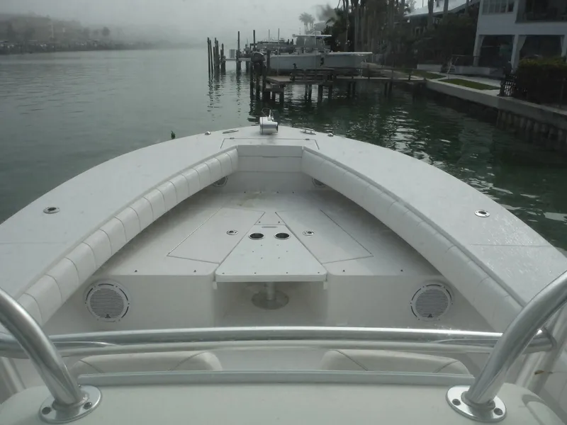 Slide: The Image of 2012 Regulator 32 Forward Seating boat docked by a calm waterfront. - 8