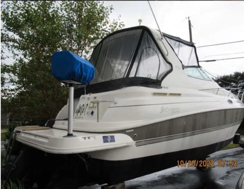 Slide: The Image of 2007 Cruisers Yachts 280 CXi Express boat on trailer, covered and parked outdoors. - 2