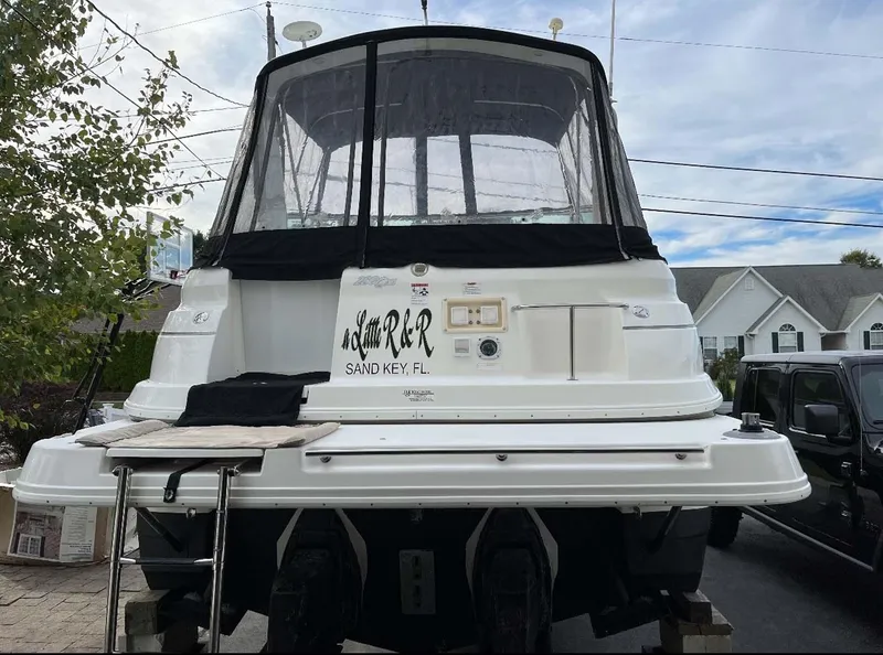 Slide: The Image of 2007 Cruisers Yachts 280 CXi Express boat with black canopy, docked in residential area. - 4