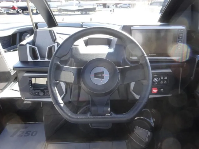 Slide: The Image of 2025 Axis T250 boat dashboard with steering wheel and control panel. - 11
