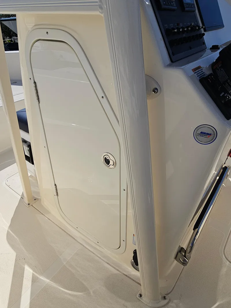 Slide: The Image of 2024 Scout Honda Seabrook 195 CF boat console with storage compartment and control panel. - 12