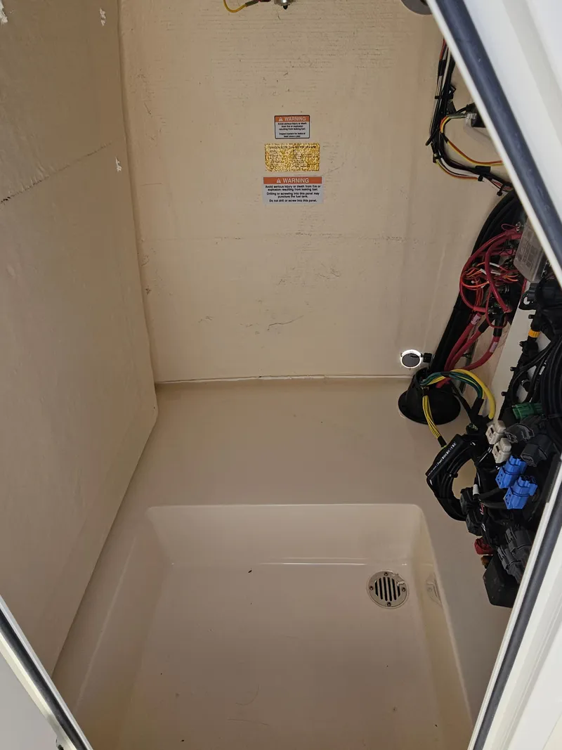 Slide: The Image of Interior compartment of 2024 Scout Honda Seabrook 195 CF with wiring and drainage. - 13