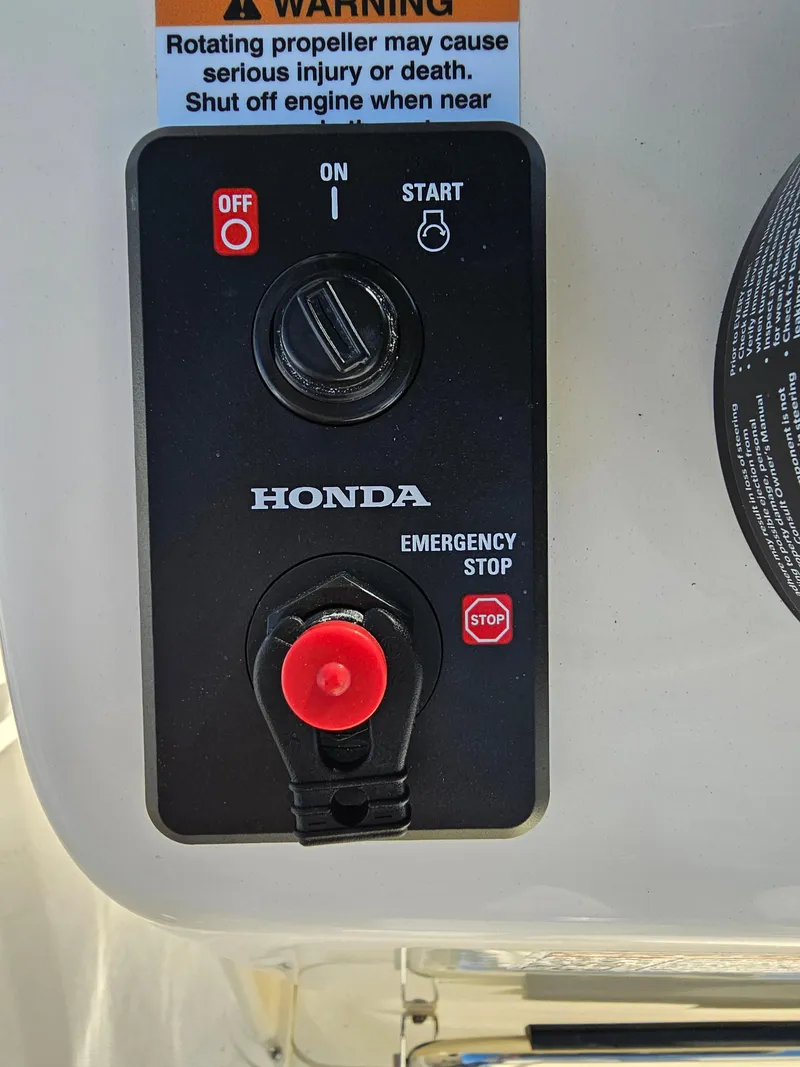 Slide: The Image of Control panel of 2024 Honda Seabrook 195 CF with emergency stop button and warning label. - 15