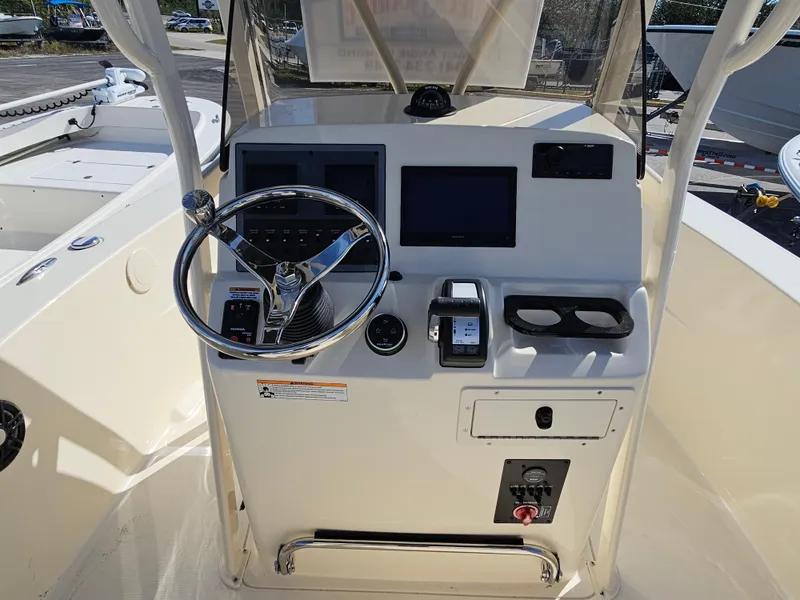 Slide: The Image of 2024 Scout Honda Seabrook 195 CF boat console with steering wheel and controls. - 19