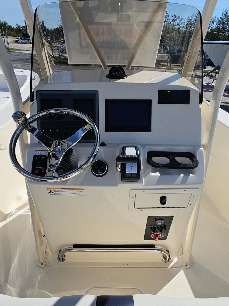 Slide: The Image of 2024 Scout Honda Seabrook 195 CF boat dashboard with steering wheel and controls. - 20
