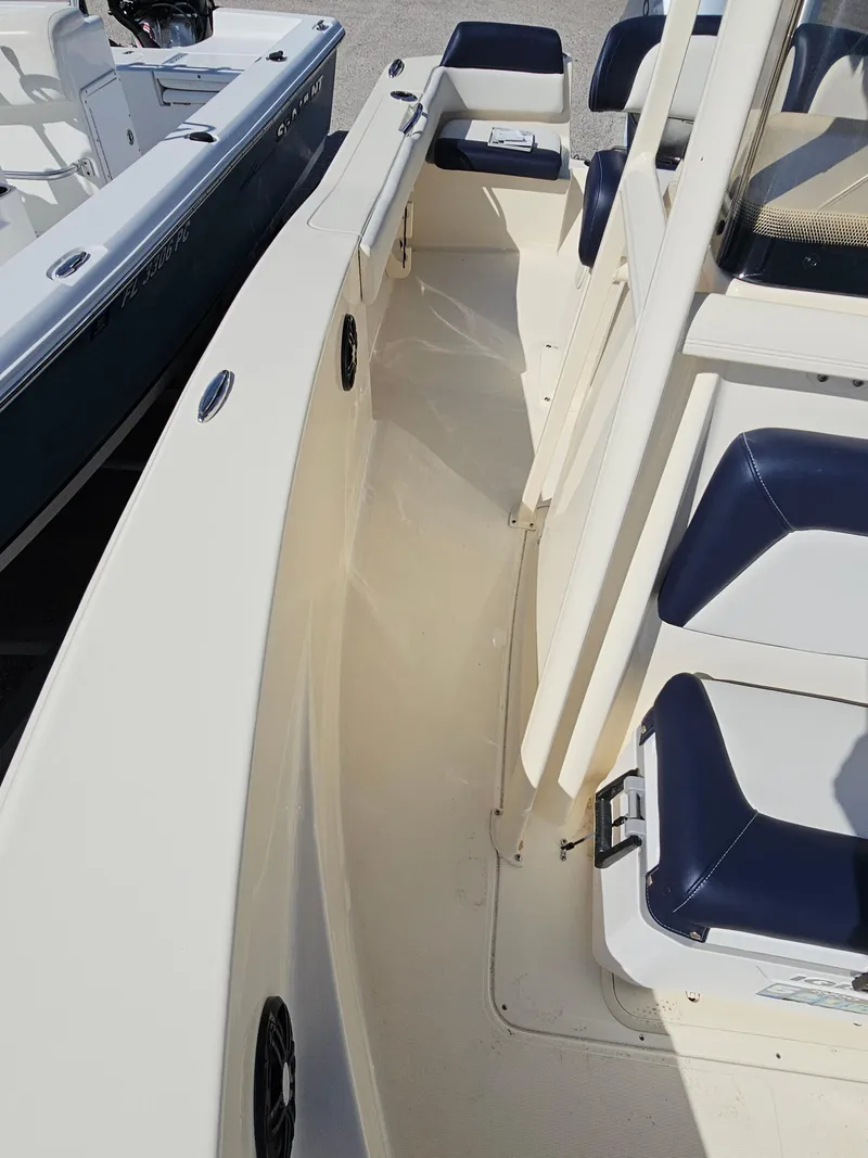 Slide: The Image of 2024 Scout Honda Seabrook 195 CF boat interior with blue and white seating. - 25