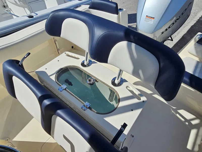 Slide: The Image of 2024 Scout Honda Seabrook 195 CF boat interior with seating and storage compartment. - 27