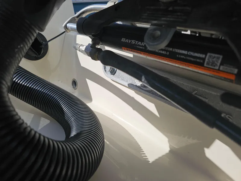 Slide: The Image of Close-up of 2024 Scout Honda Seabrook 195 CF steering cylinder and hose components. - 29