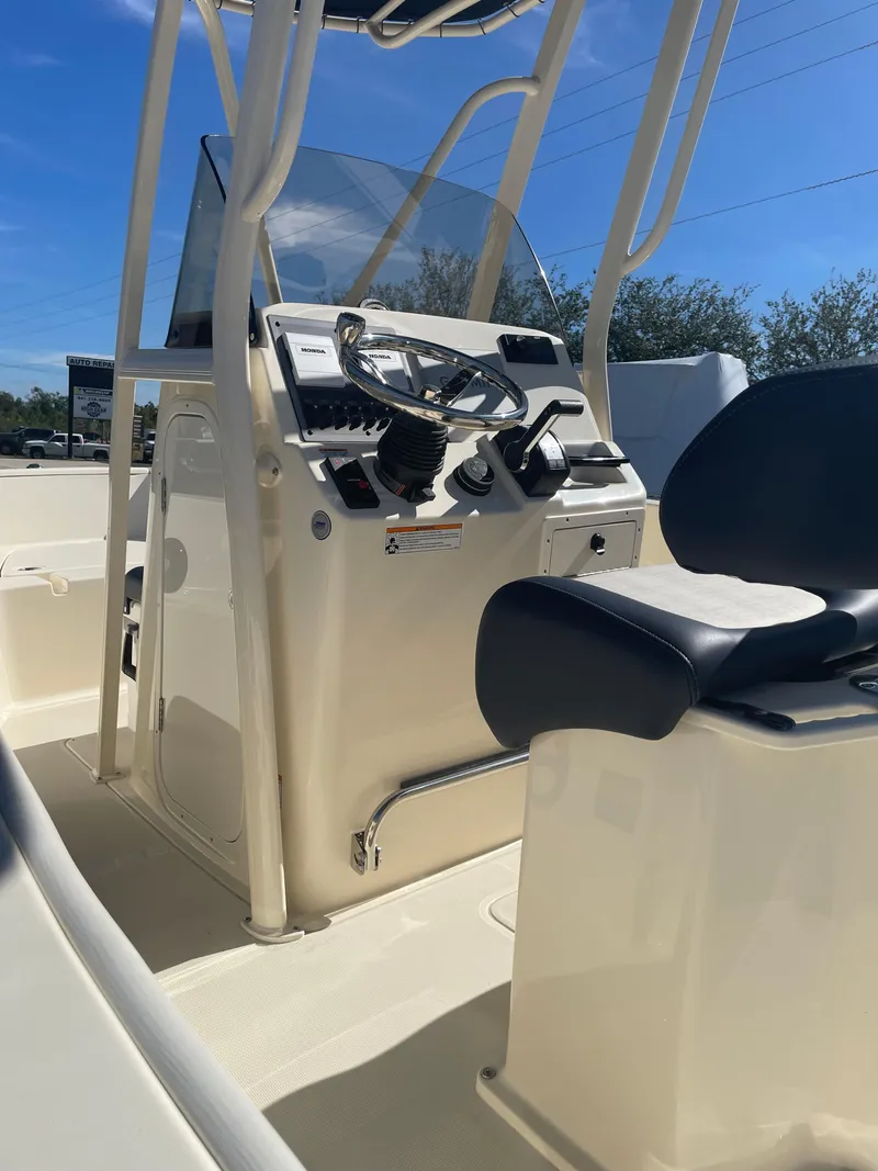 Slide: The Image of 2024 Scout Honda Seabrook 195 CF boat console with steering wheel and seating. - 35