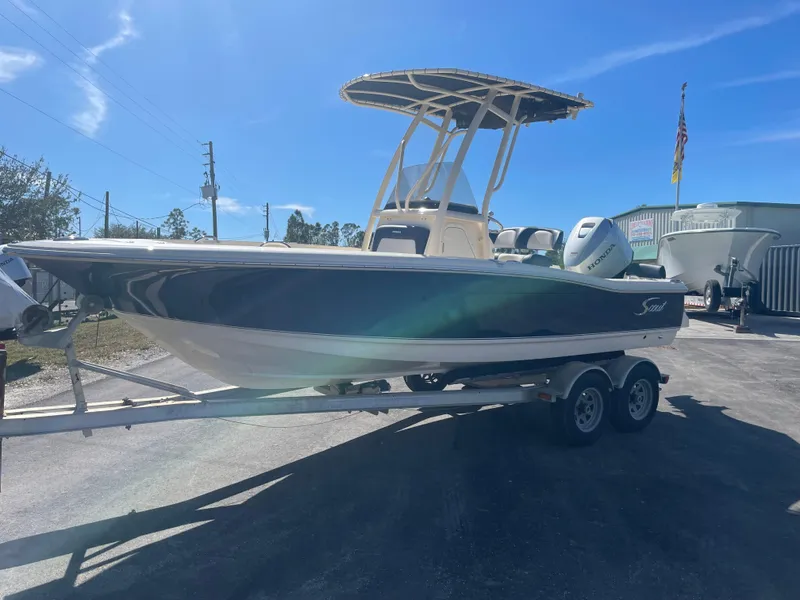 Slide: The Image of 2024 Scout Honda Seabrook 195 CF boat on trailer under clear blue sky. - 36