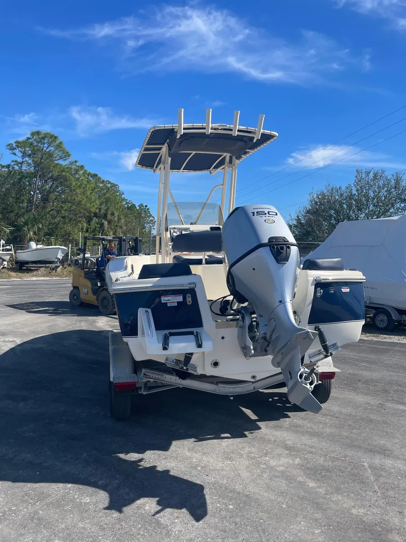 Slide: The Image of 2024 Scout Honda Seabrook 195 CF boat with outboard motor, parked outdoors. - 37