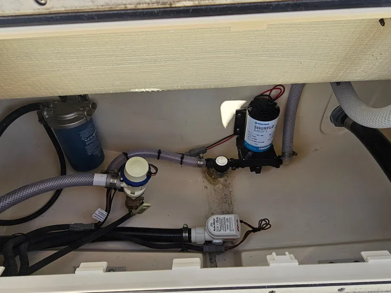 Slide: The Image of 2024 Scout Honda Seabrook 195 CF boat plumbing system with filters and hoses. - 8