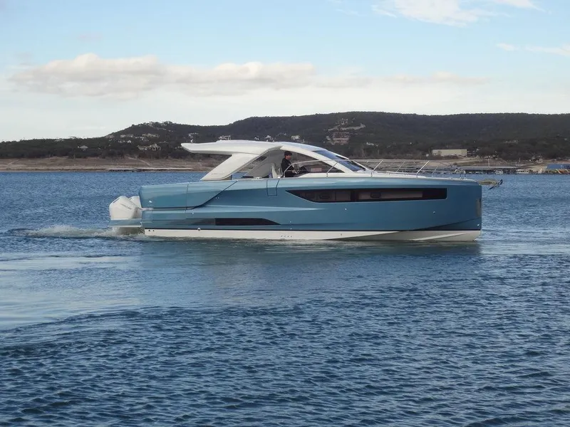 Slide: The Image of 2025 Jeanneau DB/43 OB yacht cruising on calm waters, scenic background. - 13