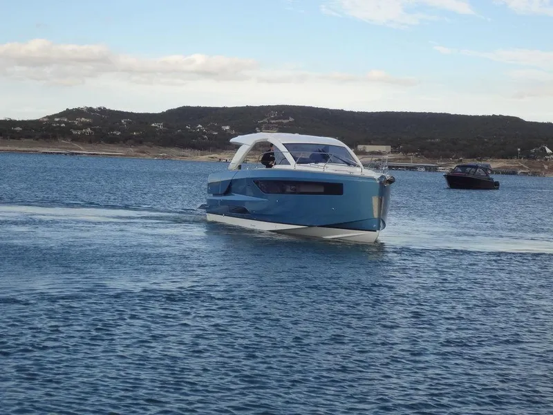 Slide: The Image of 2025 Jeanneau DB/43 OB boat cruising on a calm lake. - 15