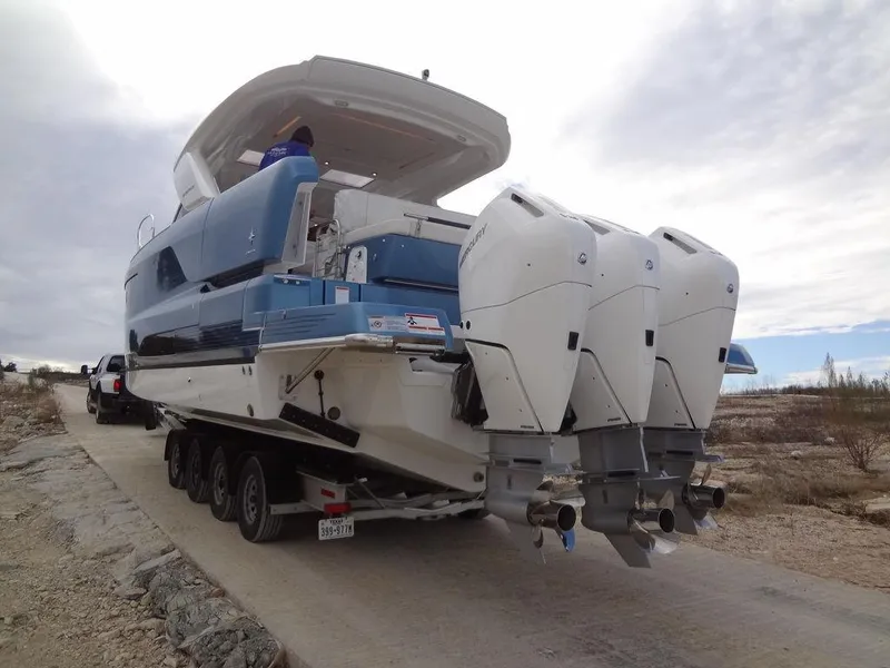 Slide: The Image of 2025 Jeanneau DB/43 OB boat on trailer with triple outboard engines. - 20