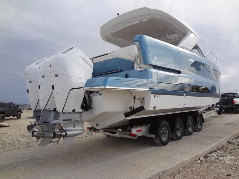 Slide: The Image of 2025 Jeanneau DB/43 OB boat on trailer with dual outboard motors. - 23