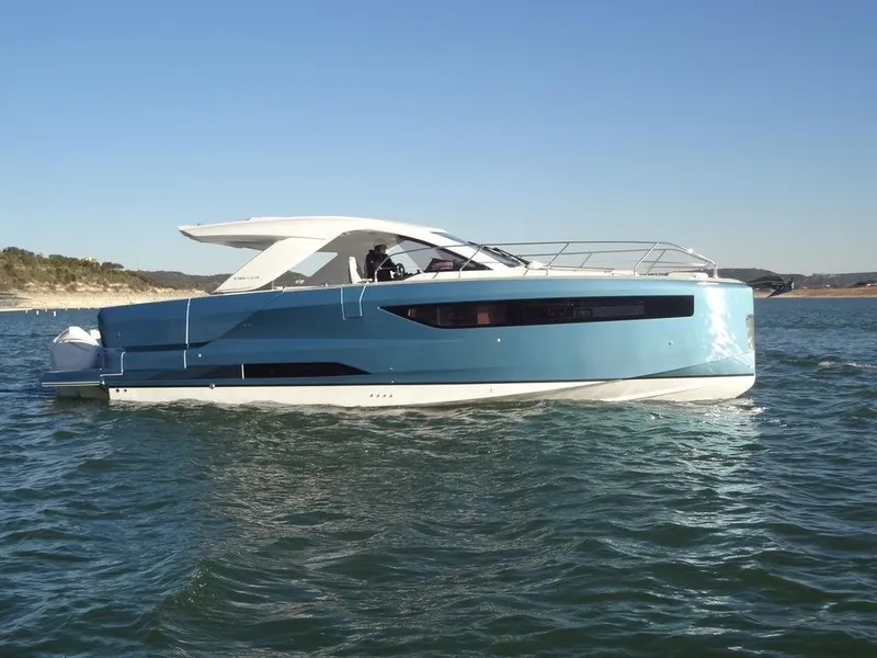 Slide: The Image of 2025 Jeanneau DB/43 OB yacht on open water, sleek design, blue hull. - 28