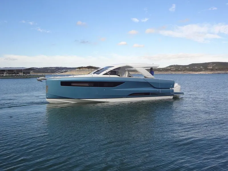Slide: The Image of 2025 Jeanneau DB/43 OB yacht cruising on calm waters under a clear sky. - 3